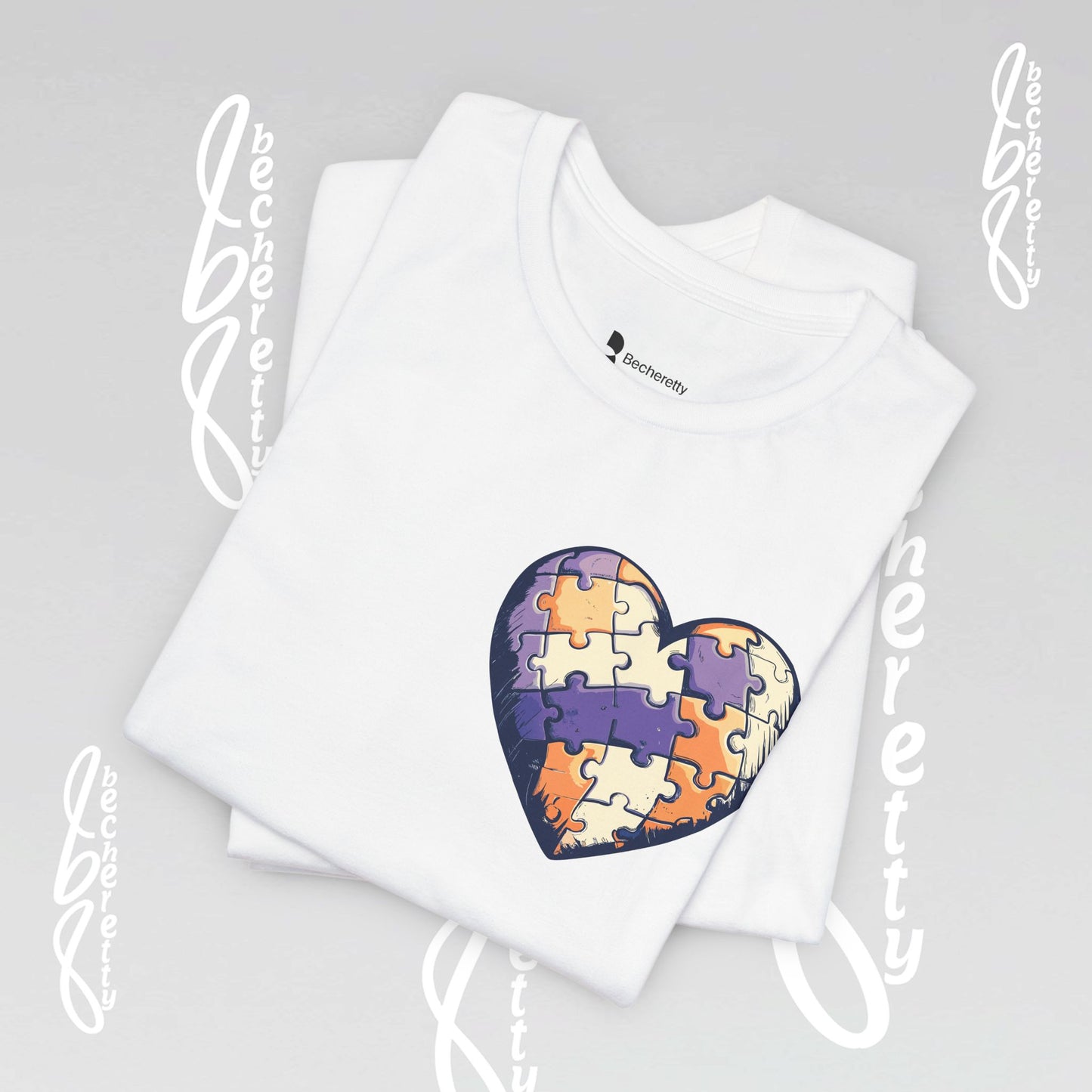 White t-shirt with a colorful heart-shaped puzzle design, on the top left corner.