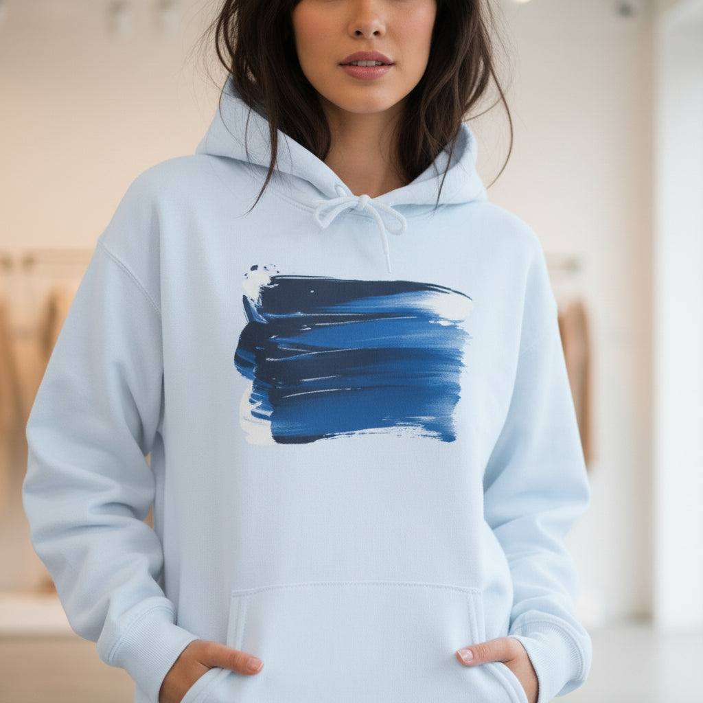 Person wearing a light blue hoodie with a blue abstract wave design.