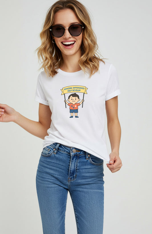 Woman wearing a white t-shirt with a graphic design of a Boy(cartoon) holding a banner: Amazing differences, help develop.
