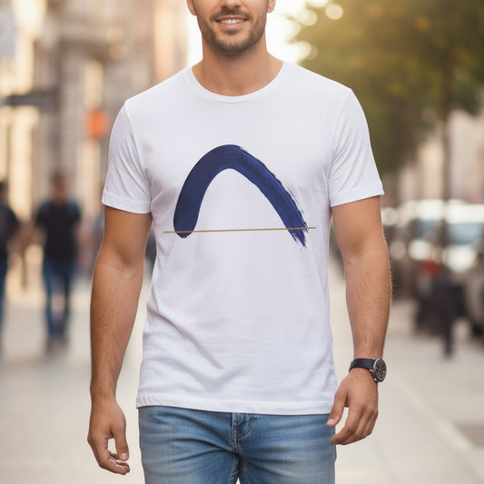 Man wearing a white t-shirt with a blue brush stroke graphic, on a city street.