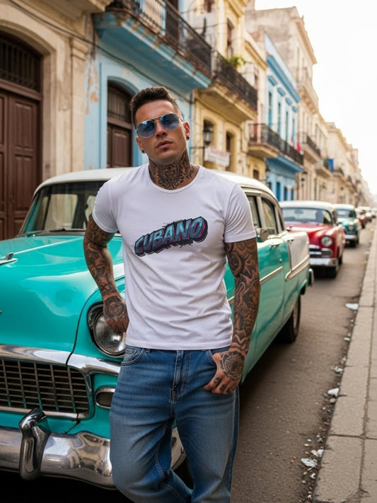 Man wearing a 'Cubano' t-shirt standing next to a vintage car on a street in a colorful urban setting.