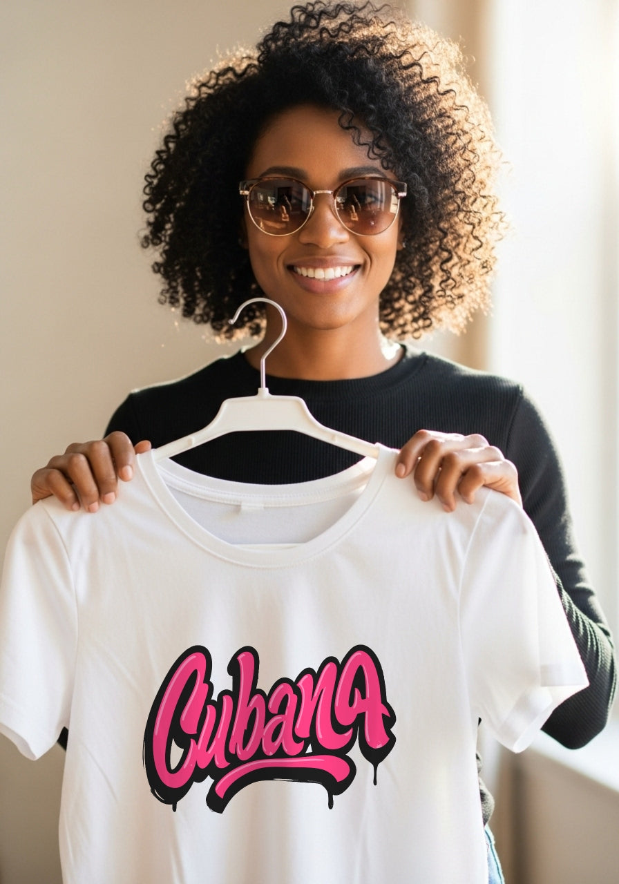 Woman holding a white t-shirt with 'Cubana' printed on it, wearing sunglasses.