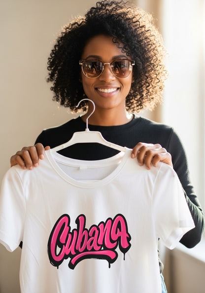 Woman holding a white t-shirt with 'Cubana' printed on it, wearing sunglasses.