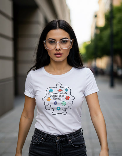 A white t-shirt with two outline faces, different and colorful puzzle pieces, and the slogan: different minds create rare Beauty.