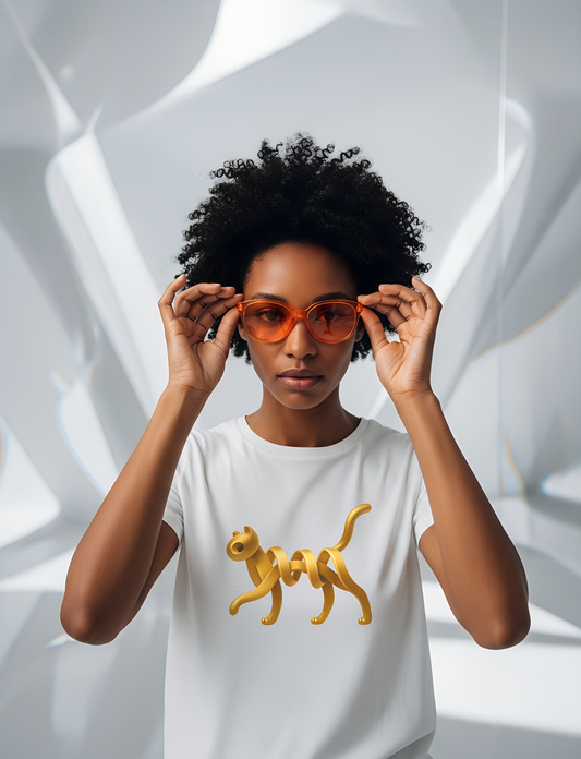 Person wearing a white t-shirt with an artistic golden cat design, holding orange sunglasses.