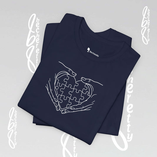 Navy blue t-shirt with a white puzzle heart between two hands, outline design style.

Details