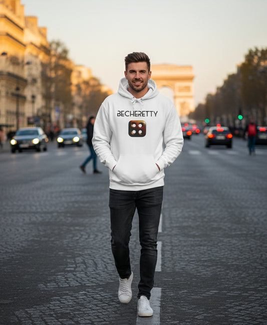 Man wearing a white hoodie with a 4 hole dice, and Art lettering, walking on a city street.