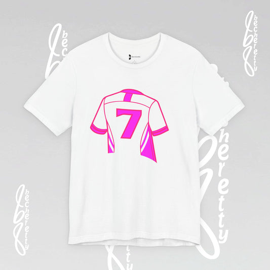 White t-shirt with pink graphic design on a gray background