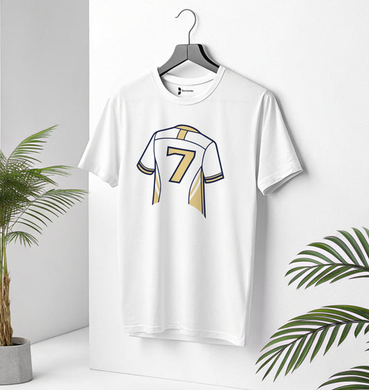 White t-shirt with a number 7 color Gold, design on a hanger against a white background with green leaves.