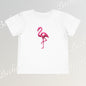 White t-shirt with a pink flamingo design on a light gray background