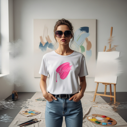 Woman wearing a white t-shirt with a pink "Love " brushstroke in an art studio.