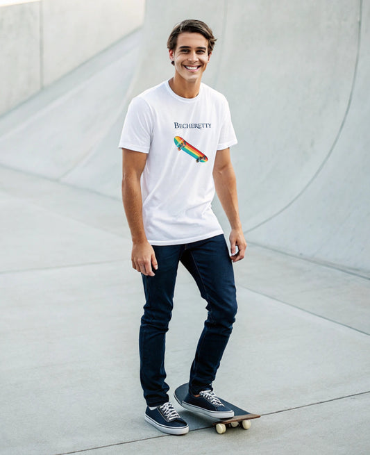 Man wearing a white t-shirt with a colorful graphic rainbow skateboard, standing on a skateboard in an urban setting.