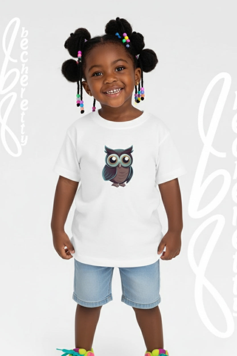 Child wearing a white t-shirt with an owl design on a light gray background