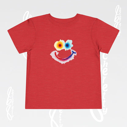 Red t-shirt with a colorful smiley face design on a light gray background