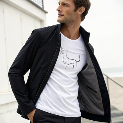 Man wearing a black jacket over a white t-shirt with a dog graphic, standing outdoors.