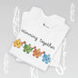 White t-shirt with colorful puzzle piece design and 'Winning Together' text on a gray background.